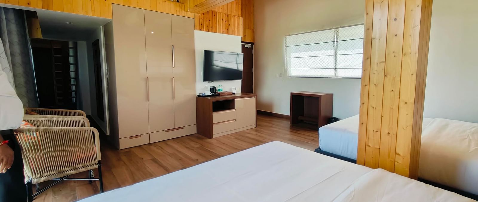 a family suite with wooden interiors at Eminence The Corbett with two beds in the room