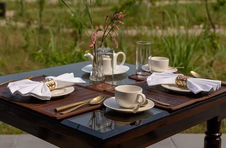 An image of high tea setup with our beautiful tents in the background - Claridges Collection