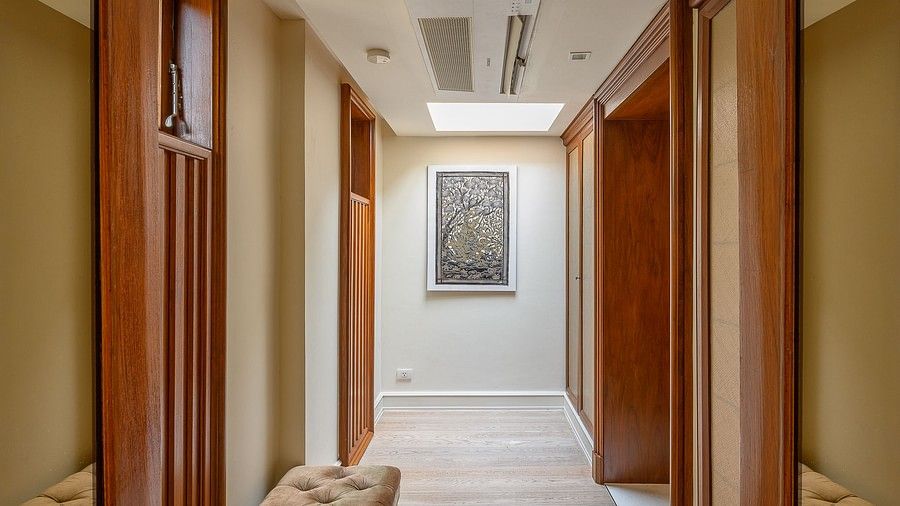 image of a corridor with a framed painting at the far end - three bedroom private pool villa