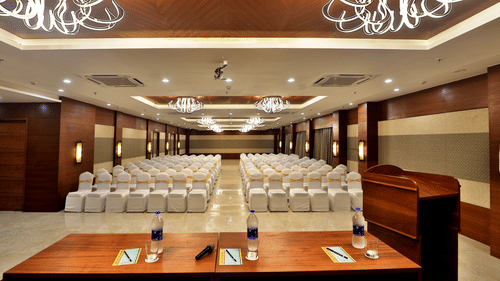 Theatre style seating arrangements with a desk on the podium inside the Banquet hall - VITS Devbhumi, Dwarka