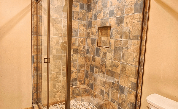 a shower cubical along with a commode in a bathroom - Historic Tapoco Lodge