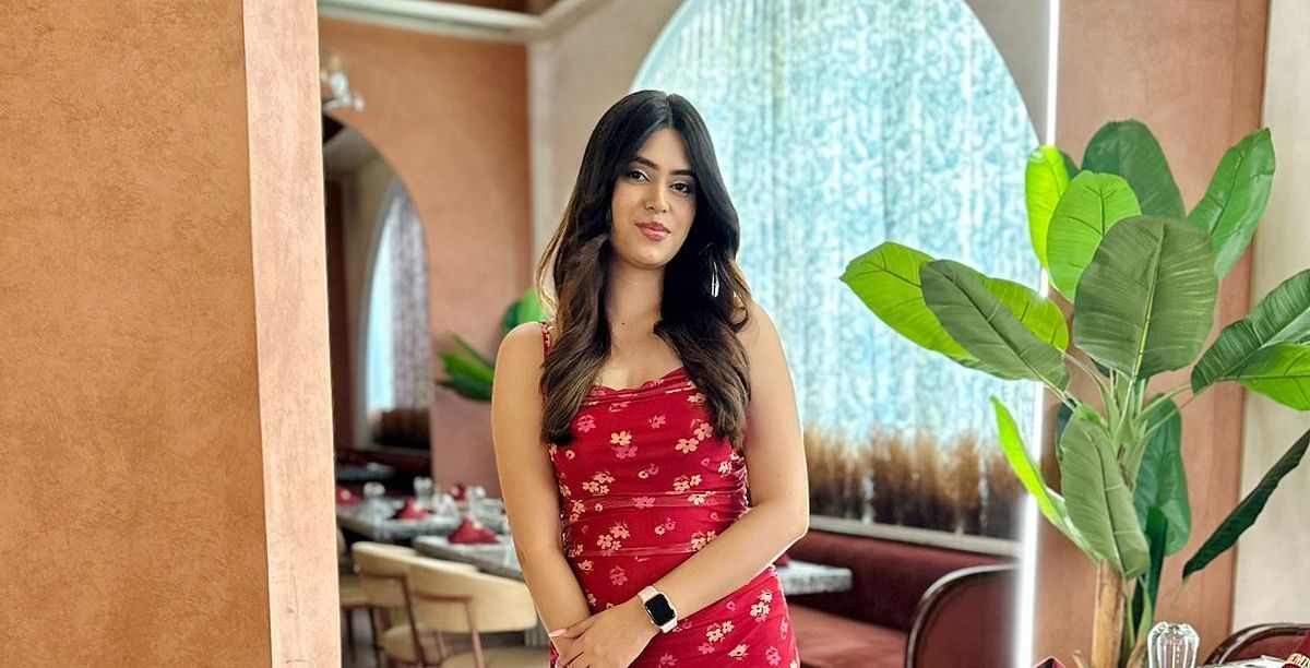 A woman posing for a photo in the warm ambiance of Themis Barbeque restaurant.