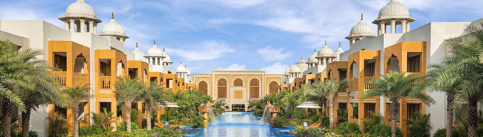 A stunning wide-angle view of our palace, with a grand central pool framed by exquisite buildings of Rajasthani architecture on both sides - Kaldan Samudhra Palace