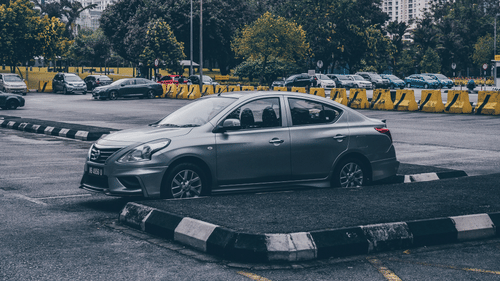 silver-sedan-parked-in-parking-lot-3795937