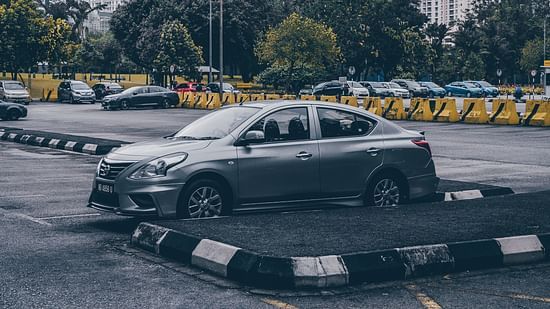 silver-sedan-parked-in-parking-lot-3795937