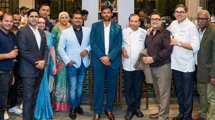 An image of a group of people posing for a photo at cake reveal ceremony - Cloud9 Sarovar Premiere, Palolem Goa