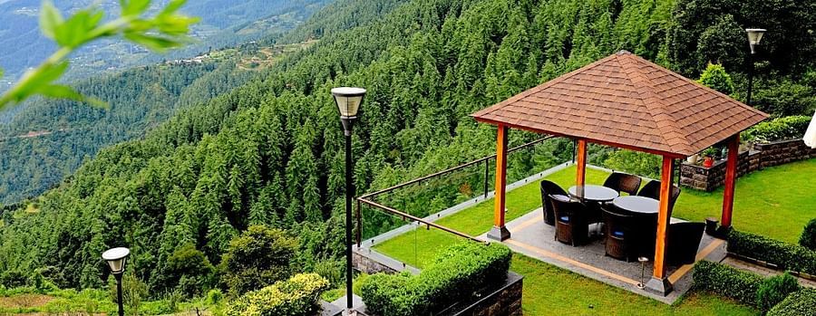outdoor sitting area at Aranya surrounded by greenery - Aranya Himalayan Retreat, Mashobra