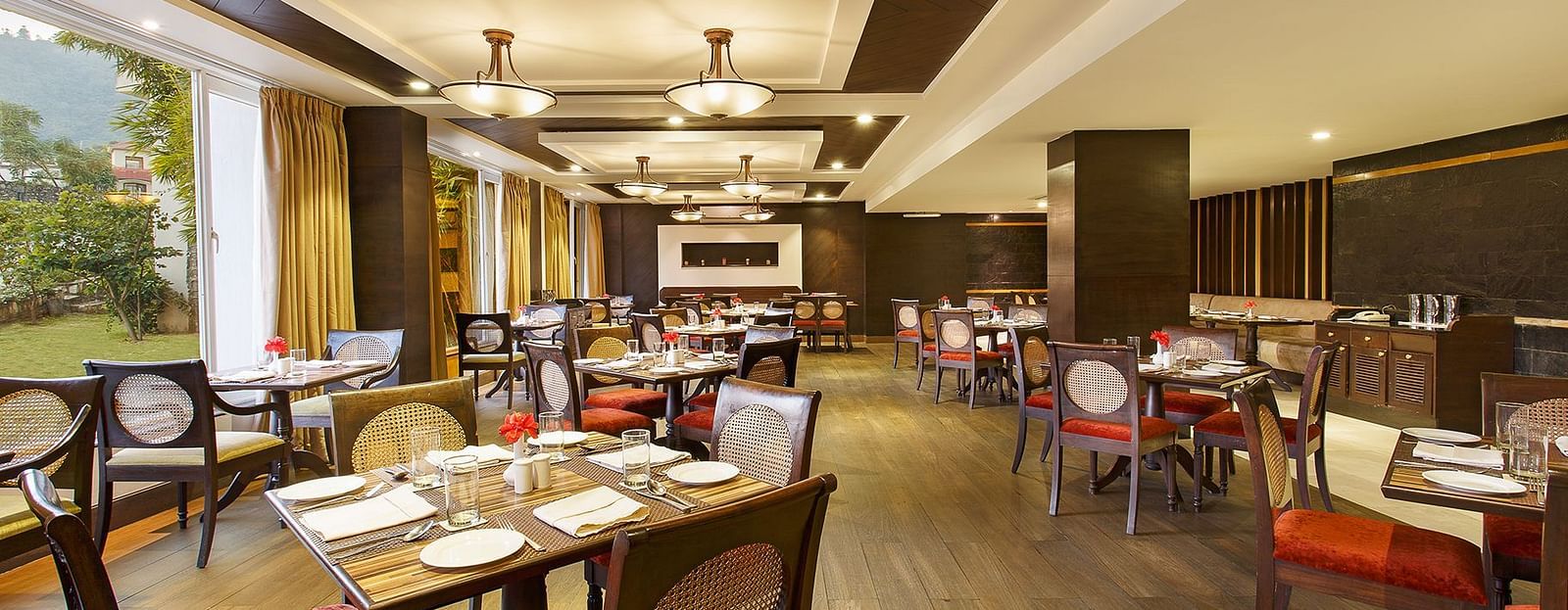 Latitude - A multi-cuisine restaurant in Rishikesh with tables and chairs in clusters spread across the space - Aloha On The Ganges, Rishikesh