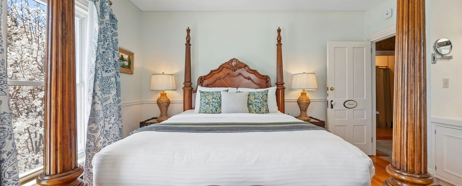 Room with ornate four-poster bed and classic decor at Hartstone Inn.