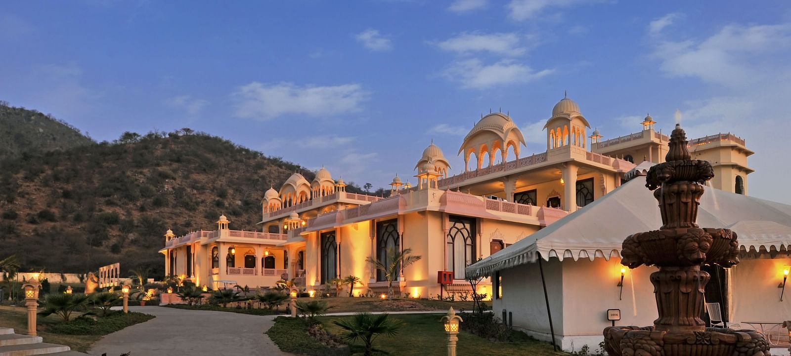 Facade of Rajasthali Resort & Spa Jaipur with a clear sky in the background.