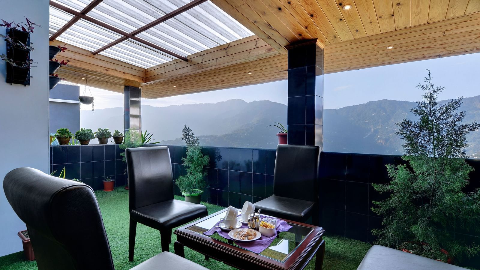 seating arrangements in an outdoor area with grass on the floor - Sumitel Shangrila, Deorali