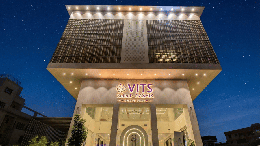 Exterior view of the VITS Select Nashik Hotels & Resorts building with signage and landscaped surroundings