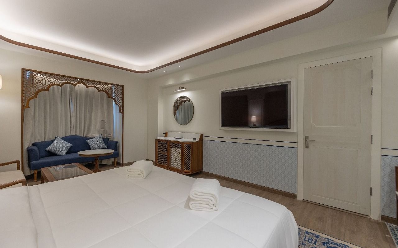 Corner view shot of the Jalrupa room featuring a double bed facing a wall mounted television at Bhagirathi by RDB Atishay.
