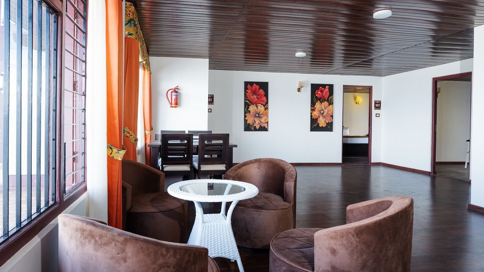 Image of a seating area with frames on the wall at Summit Sherpa Mountain Hotel & Spa, Kalimpong