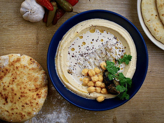 a plate of hummus and bread served