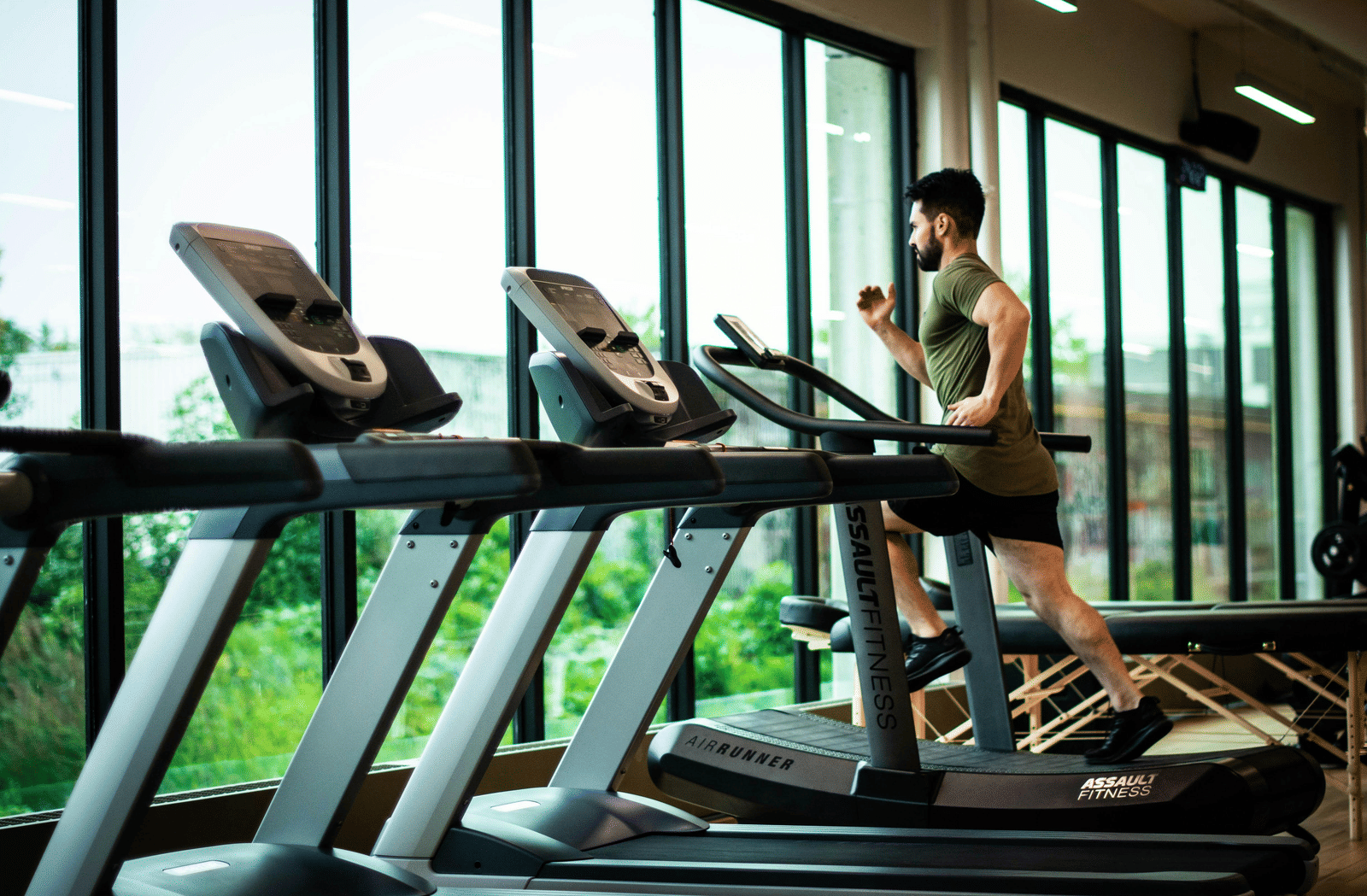 A person running on a treadmill in a gym or fitness center. 