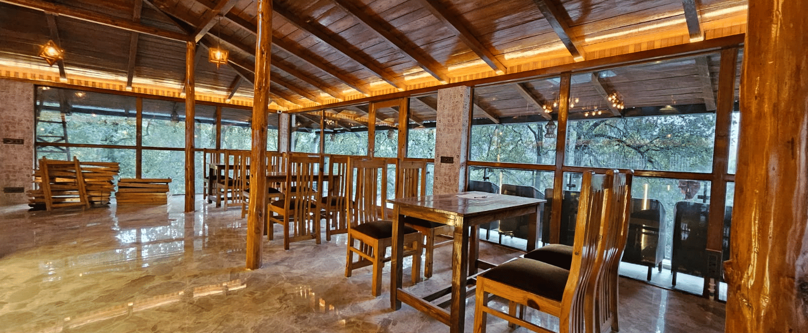 An image of the restaurant with wooden interiors featuring the chairs and tables - DLS The Emerald, Nainital