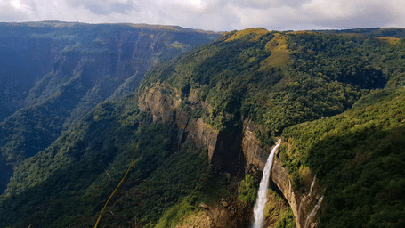 A breathtaking valley view with waterfalls cascading from cliffs.