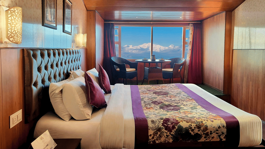 Bedroom with mountain views and warm wooden interiors at Mount Thistle Boutique Hotel, Darjeeling.