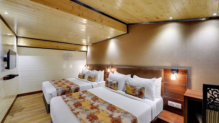 Image of Deluxe Family Room with two beds and a television in front at Yashshree Mall Road, Darjeeling.