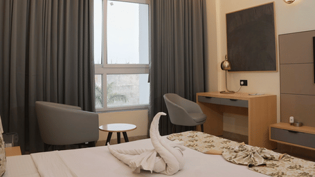 Modern executive room with cosy bed seating area and work desk at Ram Bhawan Ram Yamuna Prasad Hotel and Resort