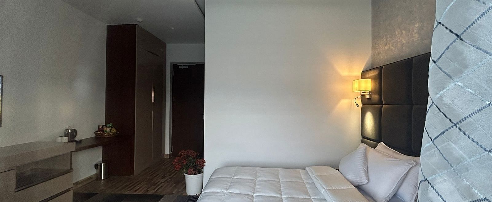 a deluxe room with modern interiors featuring a double bed at Eminence The Corbett