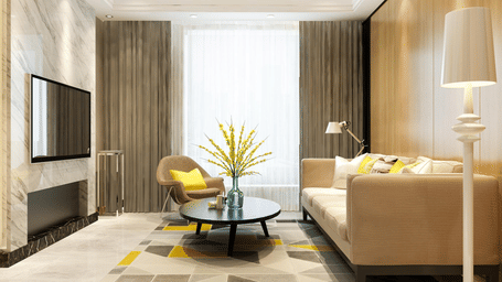 Living room of Lime Tree Hotels & Service Apartment Private Limited featuring a geometric patterned rug, a sofa, and a wall mounted television.