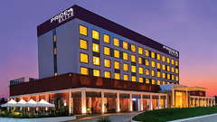 A facade image of the Pride Elite Phaltan with a dusky sky in the background