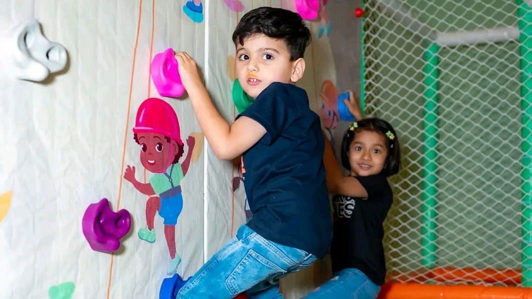 Children enjoying the wall climbing activity at Themis Barbecue House, Ambala