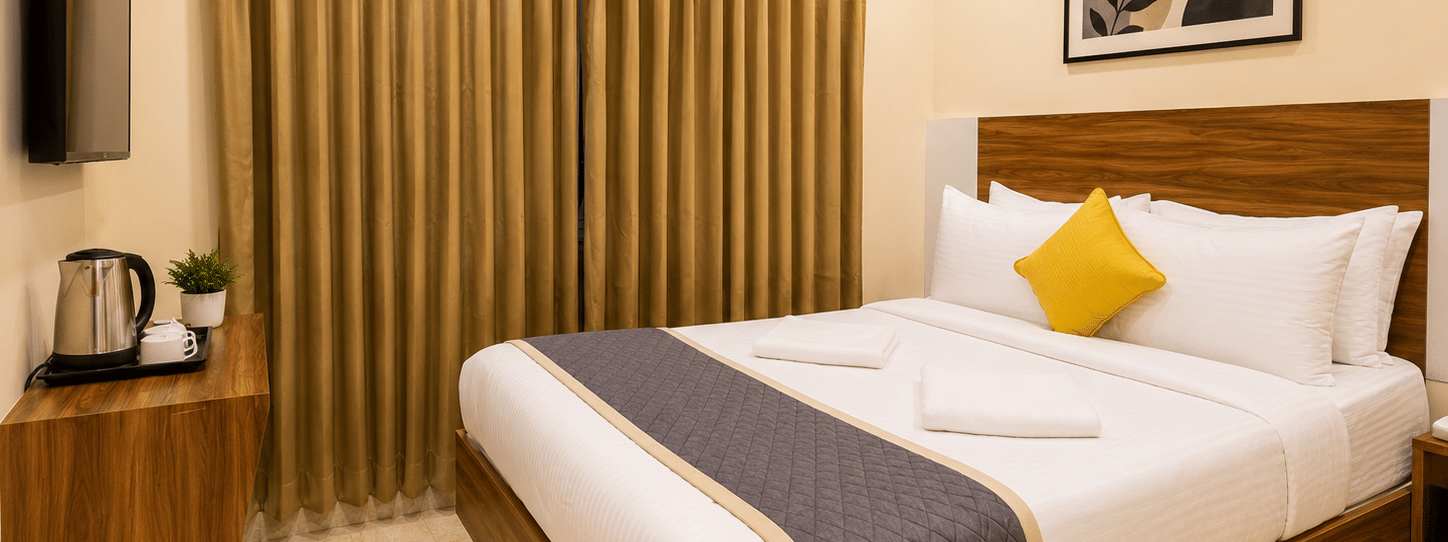 Stylish guest room at Urban Comforts with warm wooden accents, modern amenities, and relaxing interiors