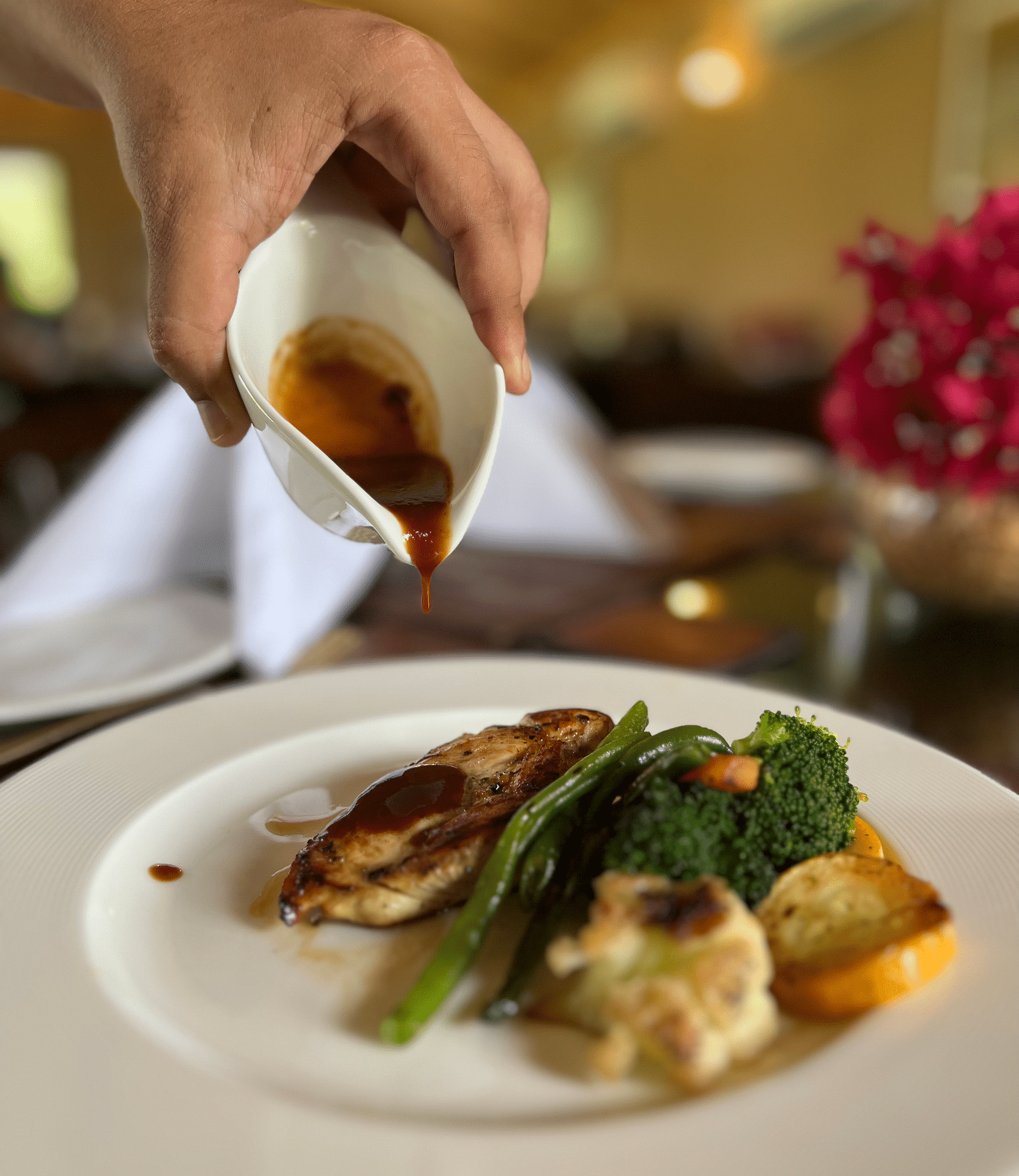Sauce being poured on Delicious food in our restaurant near Haridwar - Aalia Jungle Resort & Spa