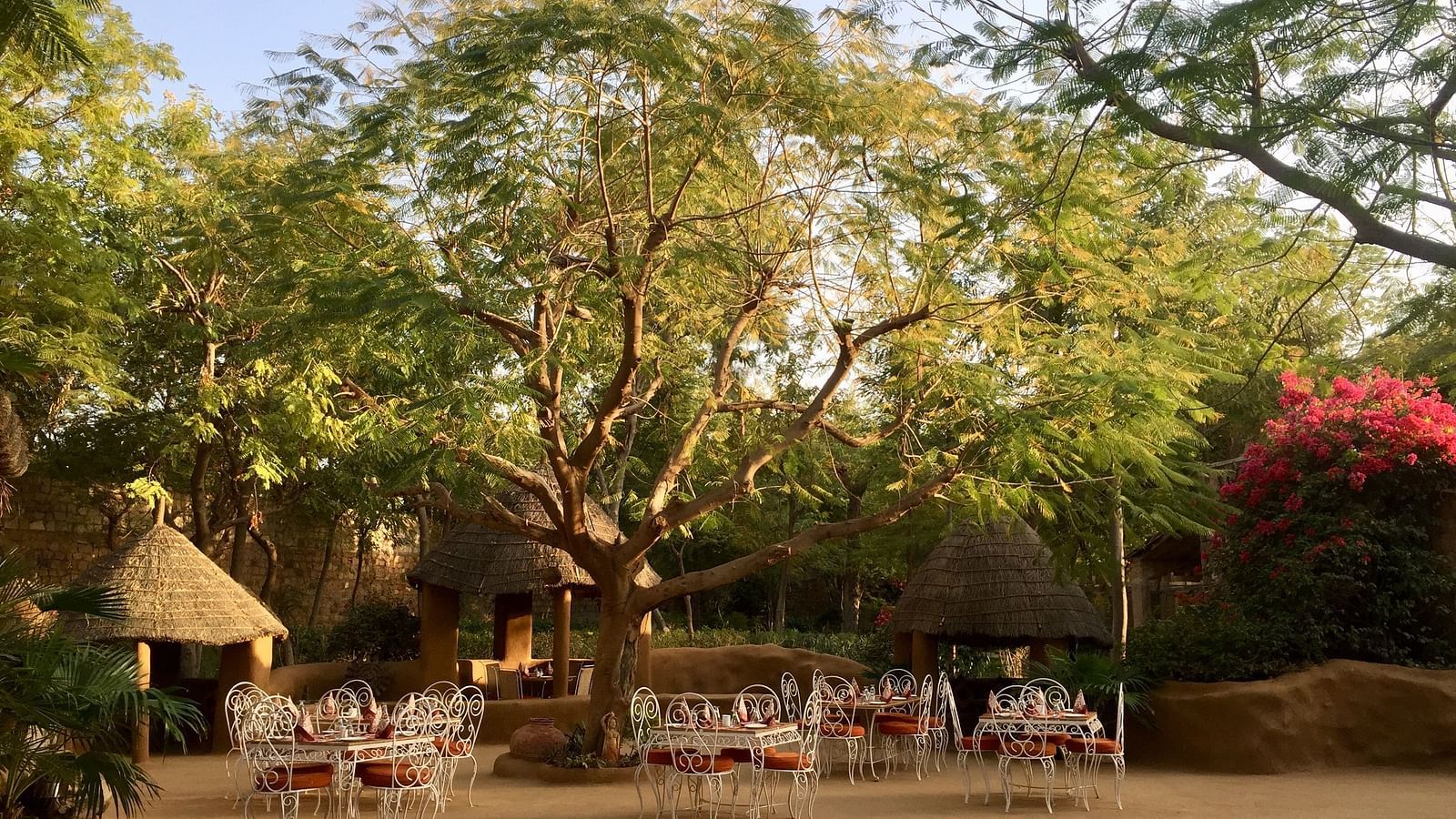 An image of the outdoor seating arrangement of the Taasli Restaurant at Manvar Shergarh - Manvar Resort & Desert Camp