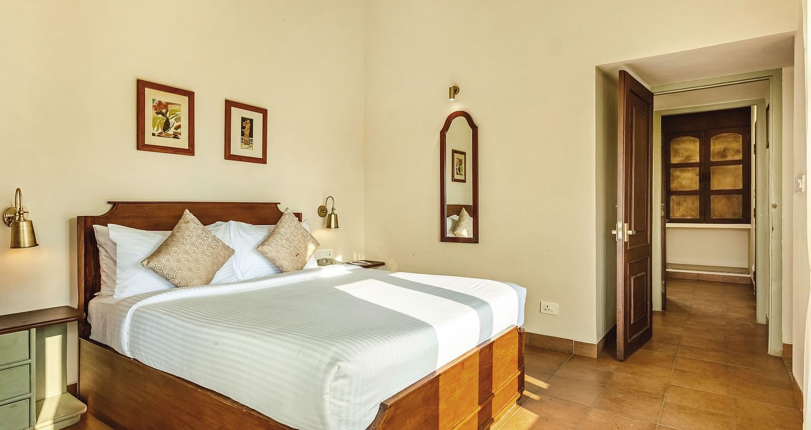 Two Bedroom Villa with Balcony at Mango Hill Shola, Ooty, with a sink, mirror, and toilet, naturally lit and neatly arranged for convenience.