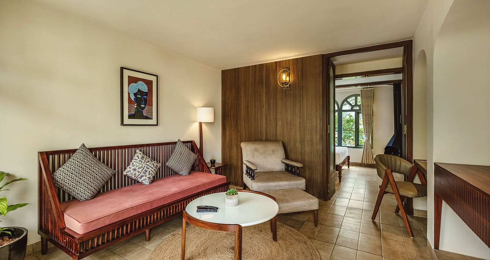 Comfortable seating area in a Mango Hill Shola suite, Ooty, featuring a plush sofa, coffee table, and warm lighting.