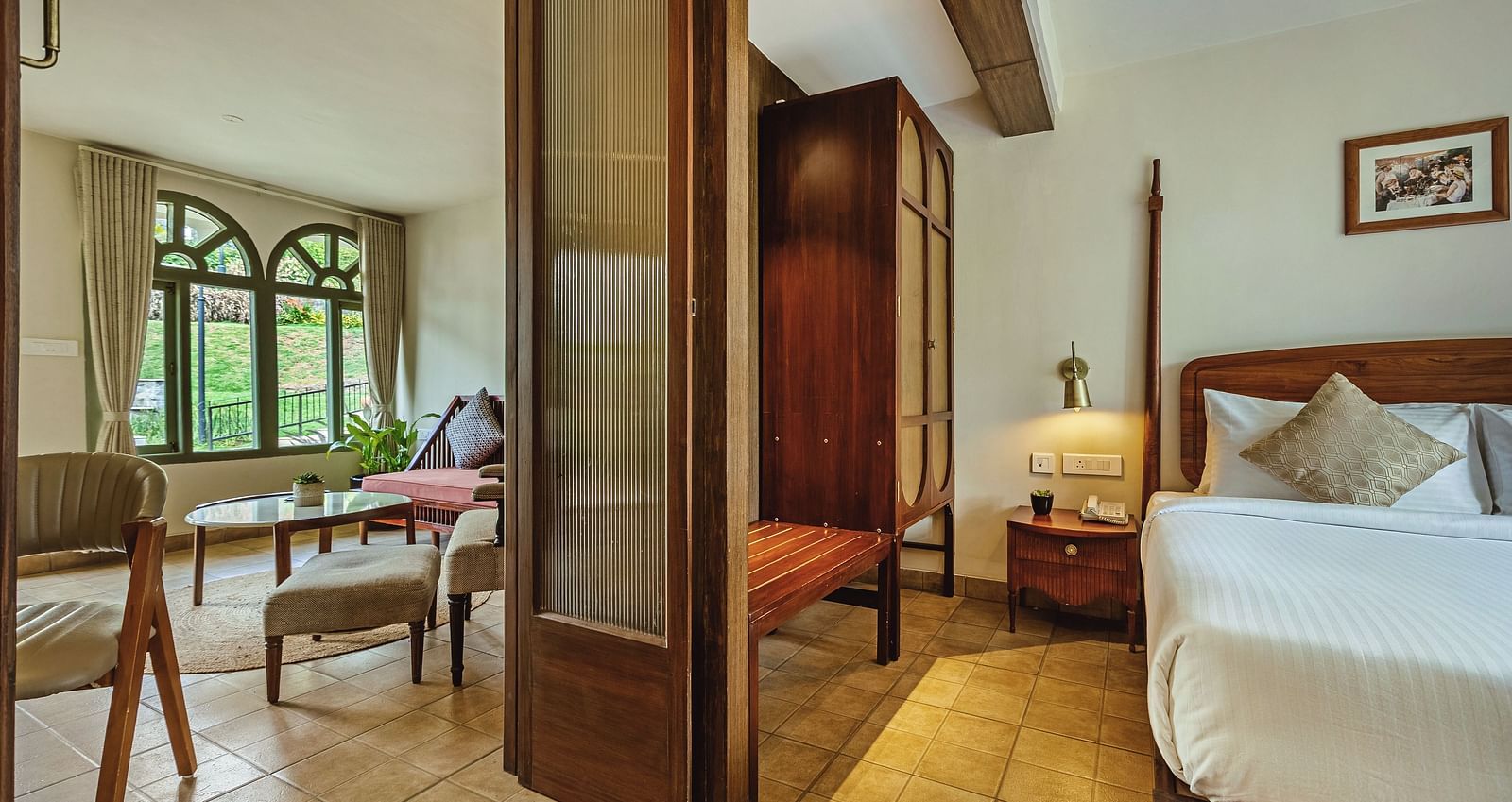 Junior Suite with Bathtub at Mango Hill Shola, Ooty with separate bedroom and sitting area, tastefully furnished in earthy tones.