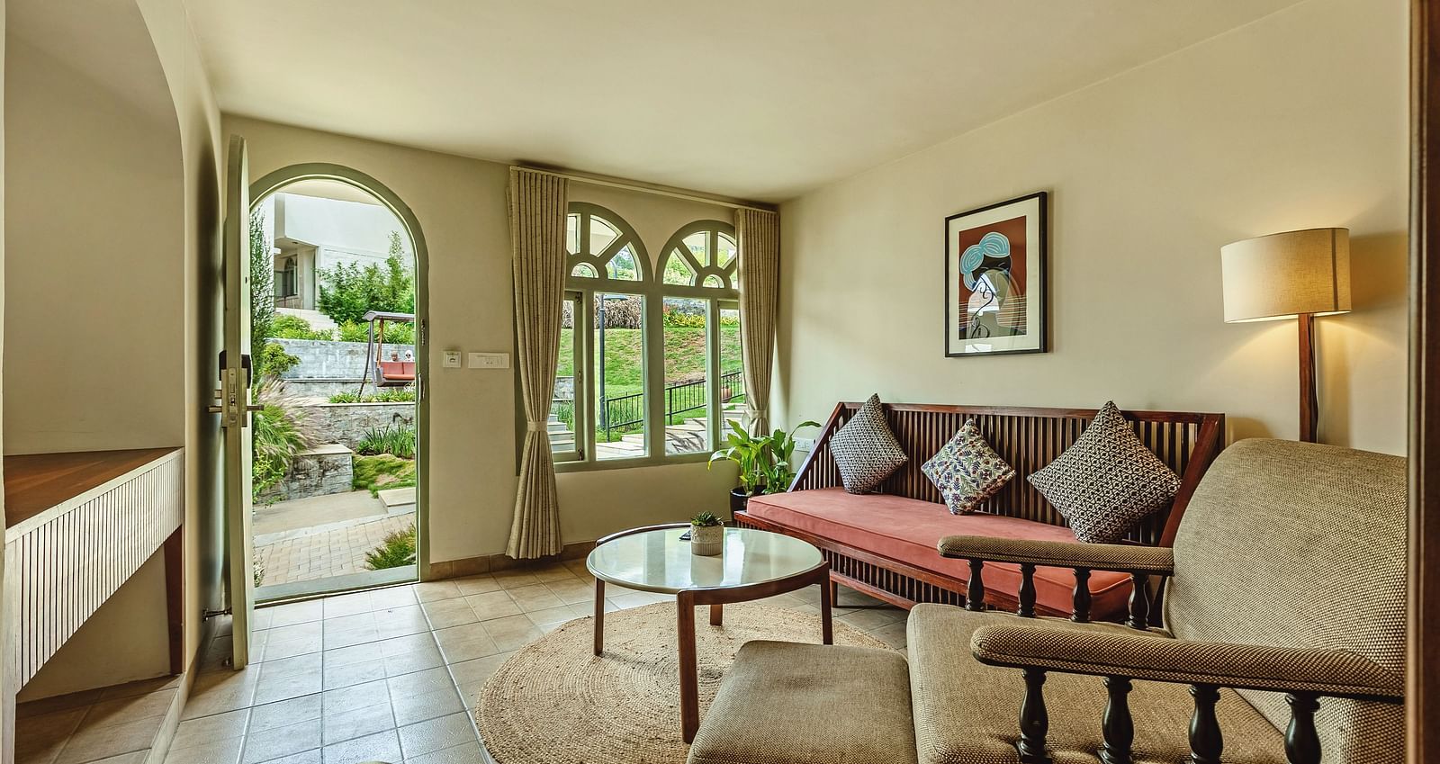 Inviting lounge space at Mango Hill Shola, Ooty with cushioned wooden seating and wide windows letting in natural light.