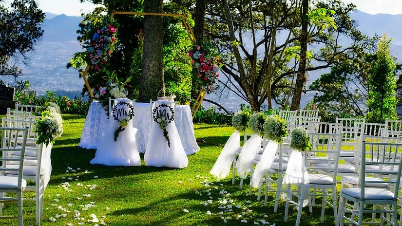Wedding arrangements in the lawn area, featuring chairs and decorations arranged aesthetically.