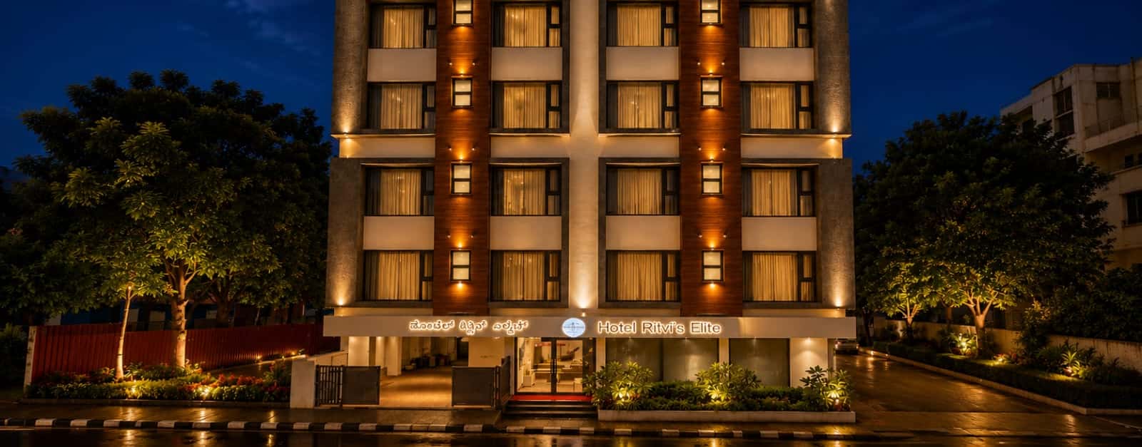 Hotel Ritvi's Elite lit up at night on 1st Cross Road, Mission Road, in central Bengaluru
