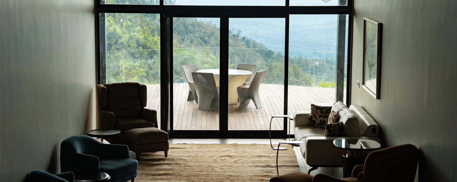 A spacious living room at Stanley Revelation with floor-to-ceiling windows and a view of the mountains.