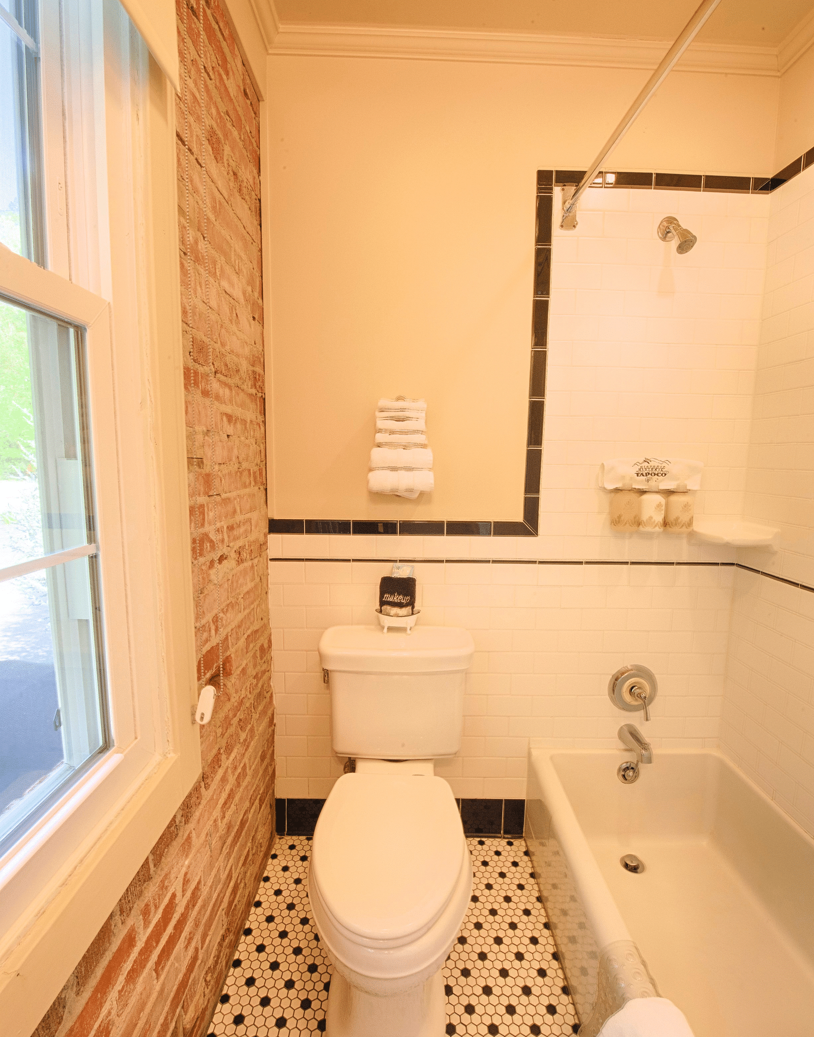 a close up image of the commode in a bathroom with a bathtub besides it - Historic Tapoco Lodge