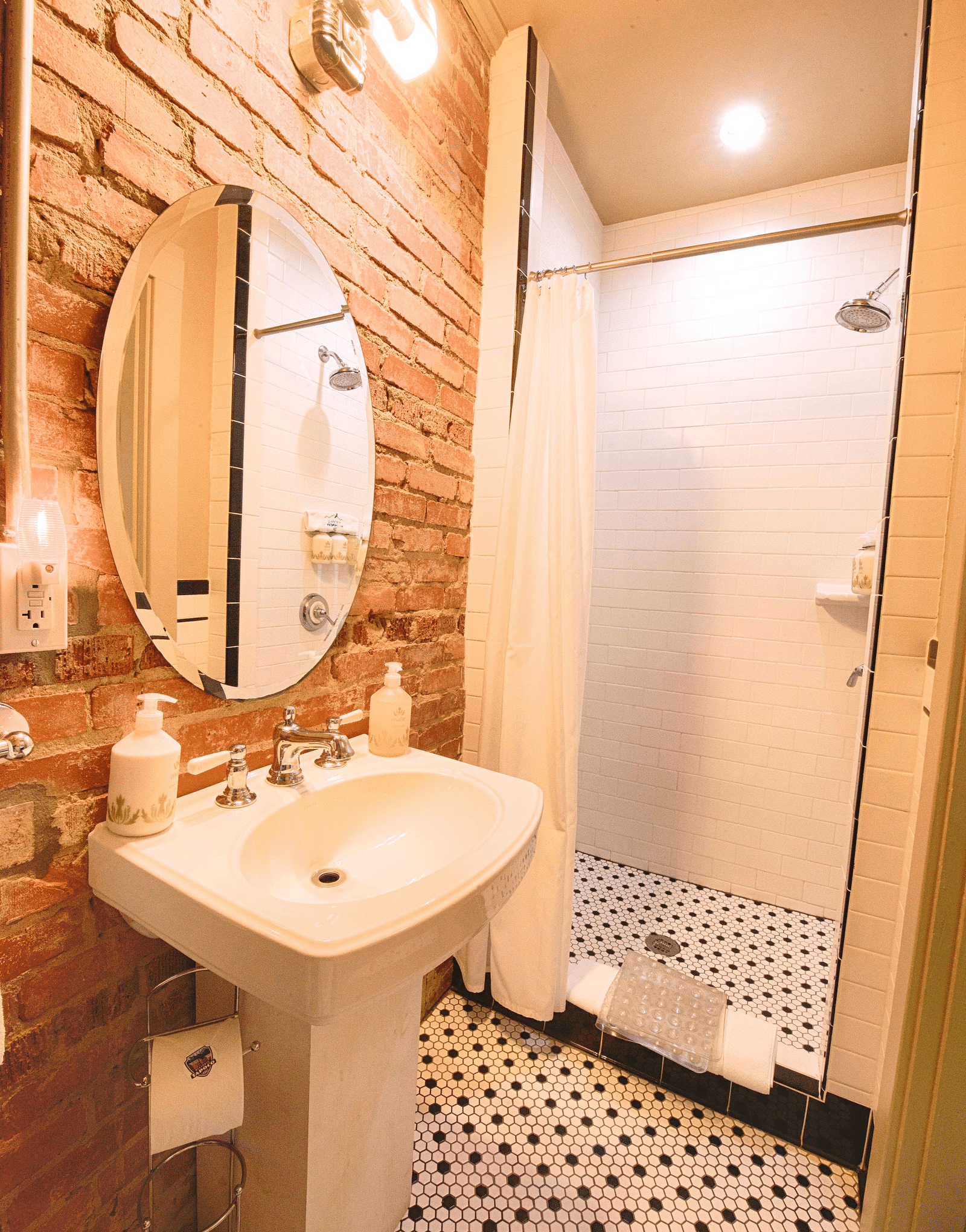 corner view image of a bathroom with a shower cubical in the corner - Historic Tapoco Lodge