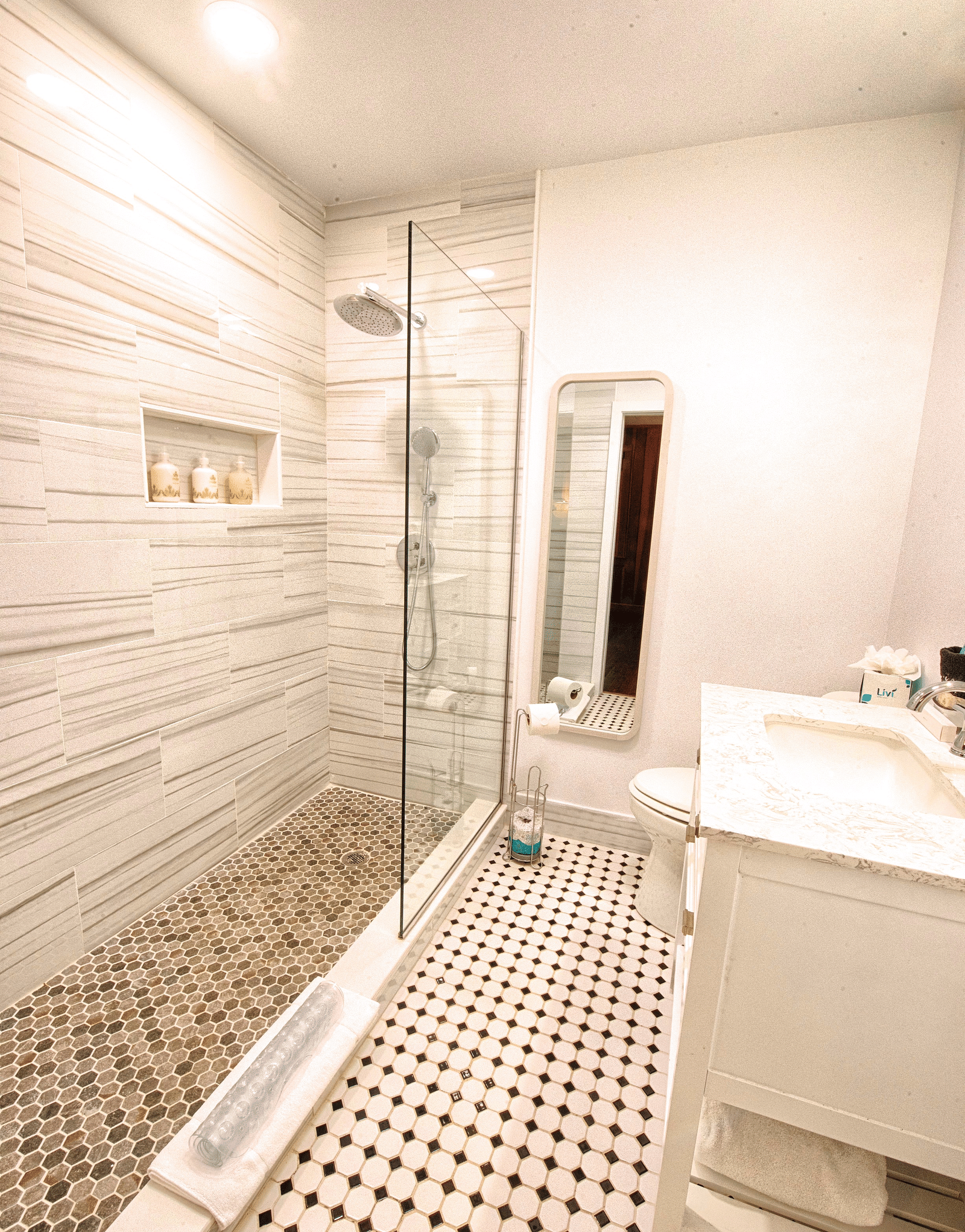 a bathroom featuring a full length mirror along with a wash basin right opposite to the shower area - Historic Tapoco Lodge
