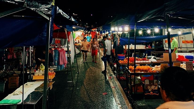 image of a street with shops around it in the night