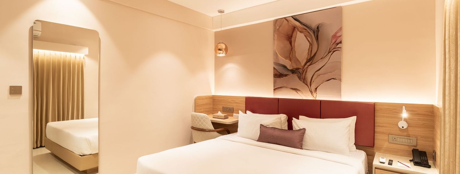 King-sized bed with elegant decor in The Premium Rooms at TGI Livancia The Sojourn, Bangalore.