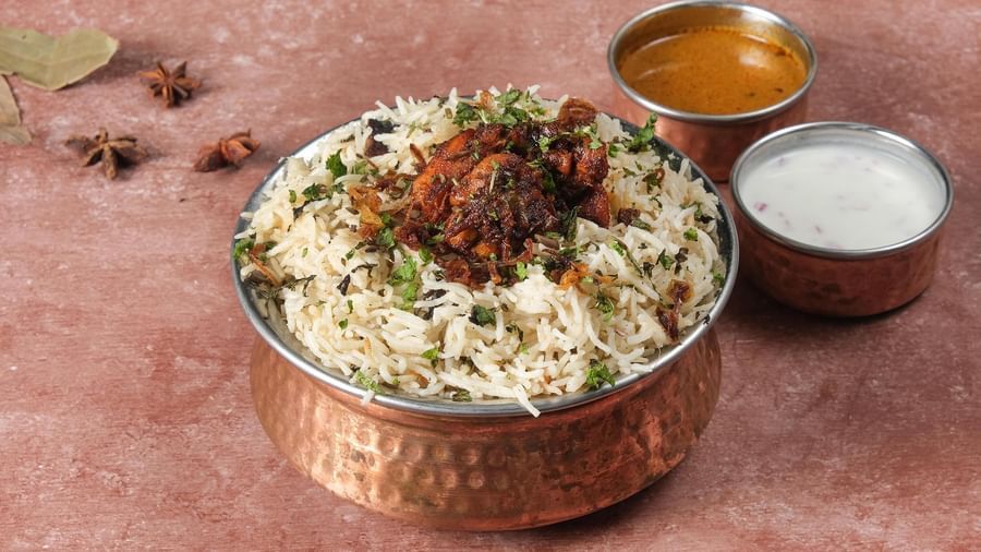 Masala rice with raita and a gravy served at Monday Hotels Amalapuram Heights.