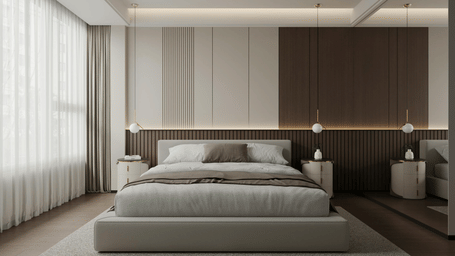 Large bed with grey bedding positioned between 2 white bedside tables with hanging globe lights against a panelled cream and brown wall.