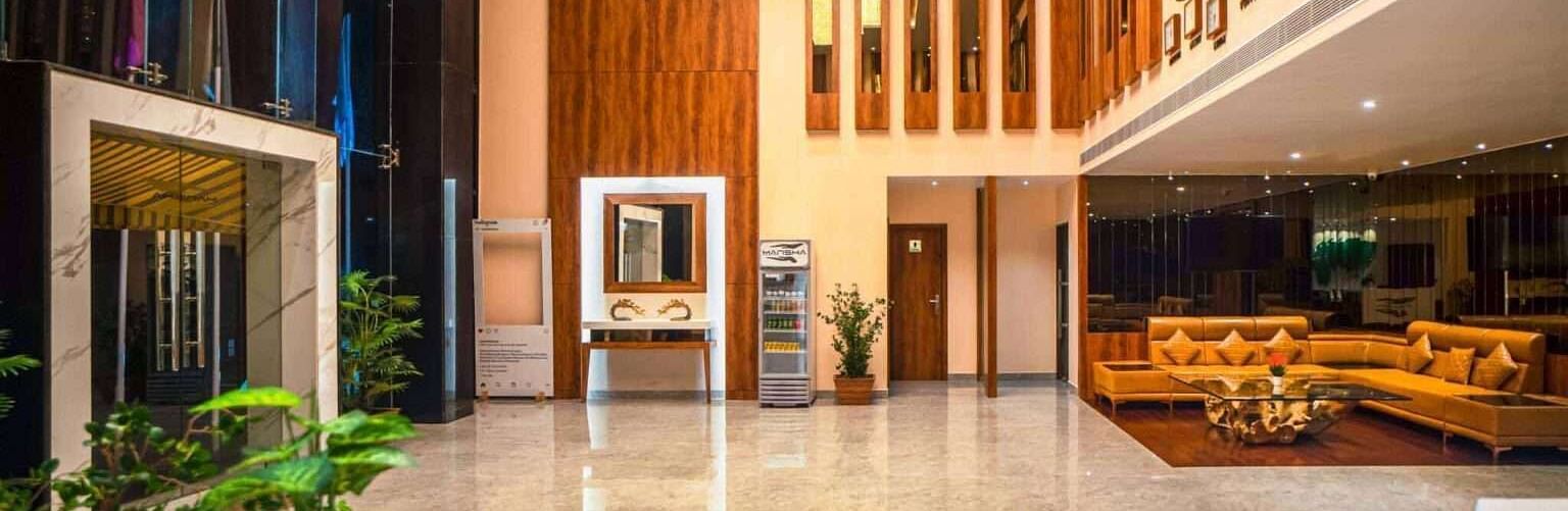 The spacious and modern lobby of Mansha Palace features elegant wooden accents and comfortable seating areas.