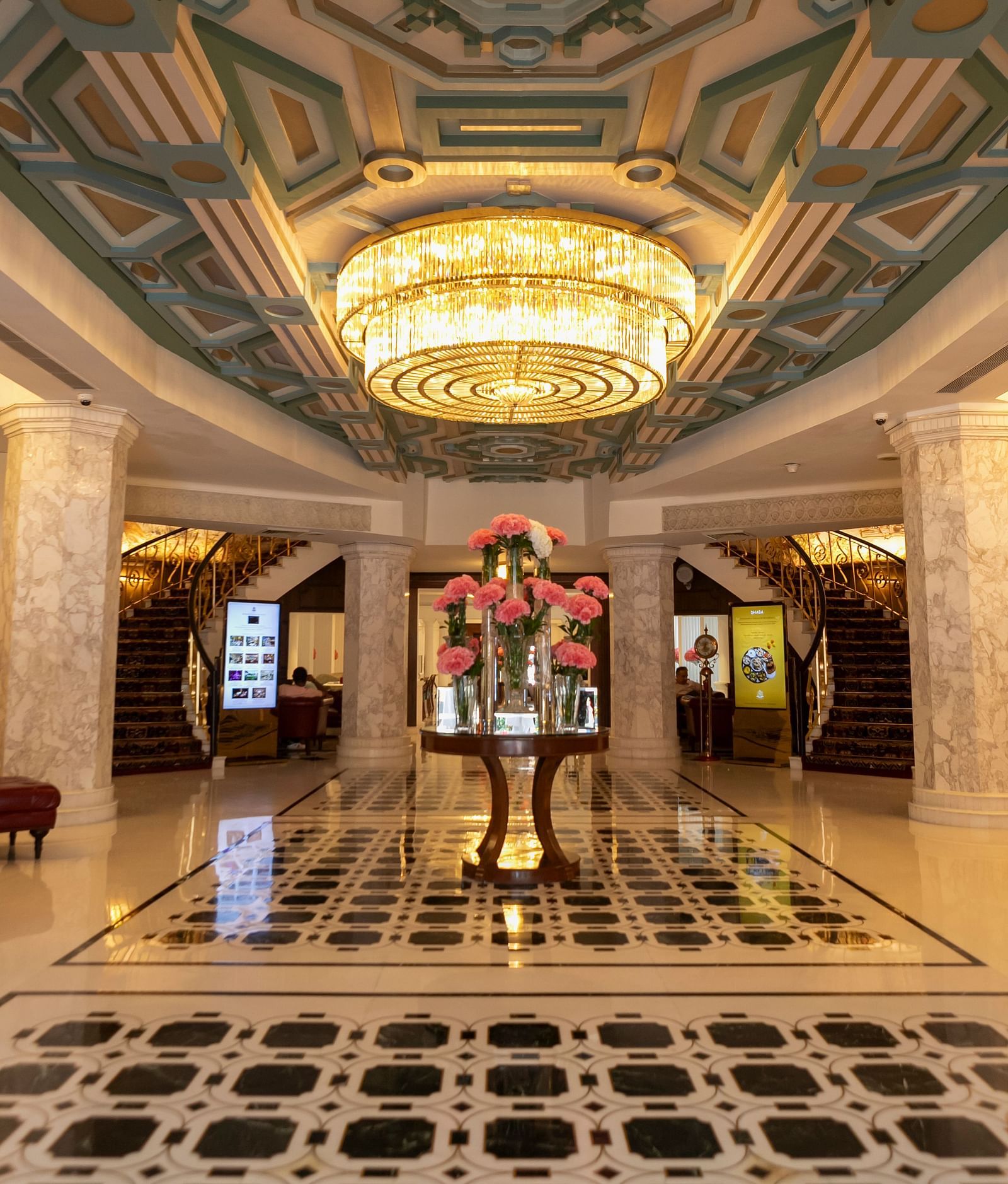 A lobby image of the The Claridges New Delhi with a chandelier hanging - Claridges Collection