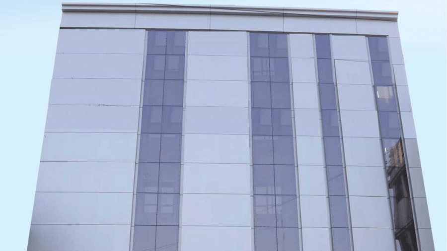 Lords Studio Inn, Jamnagar facade with clouded sky in the background