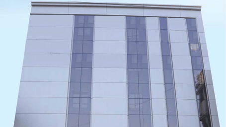 A digital rendering of a modern, red and white building with the 'Lords Inn' logo - Lords Hotels & Resorts